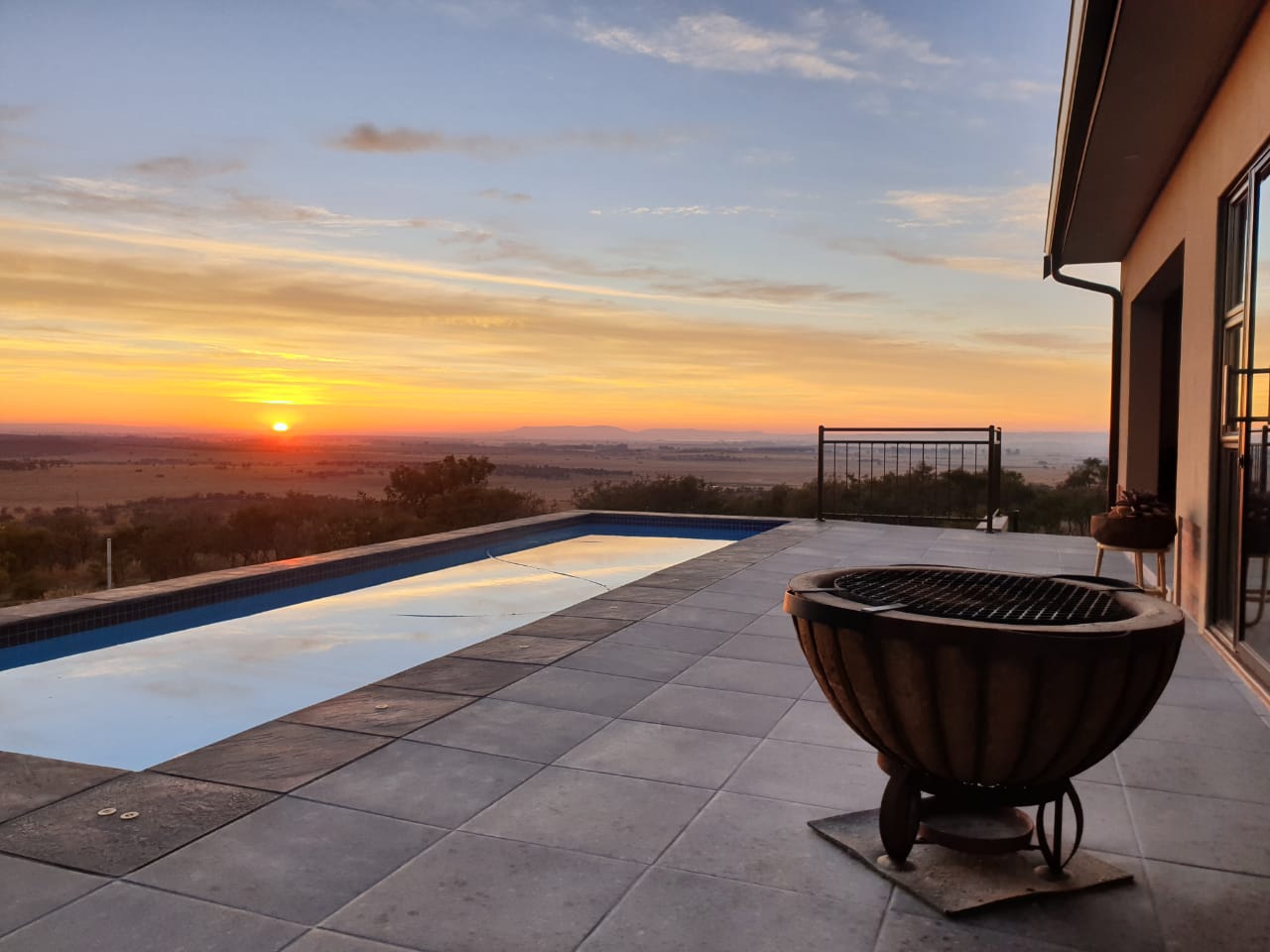 Lekwena Wildlife Estate view from home with pool and sunset