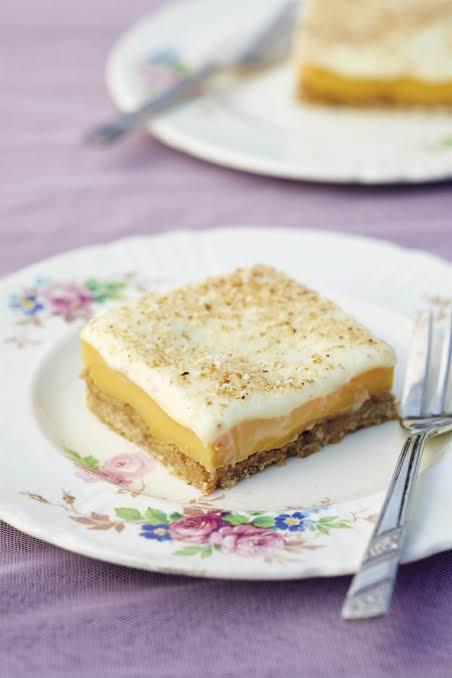 lemon fridge tart slice on ceramic plate with cake fork