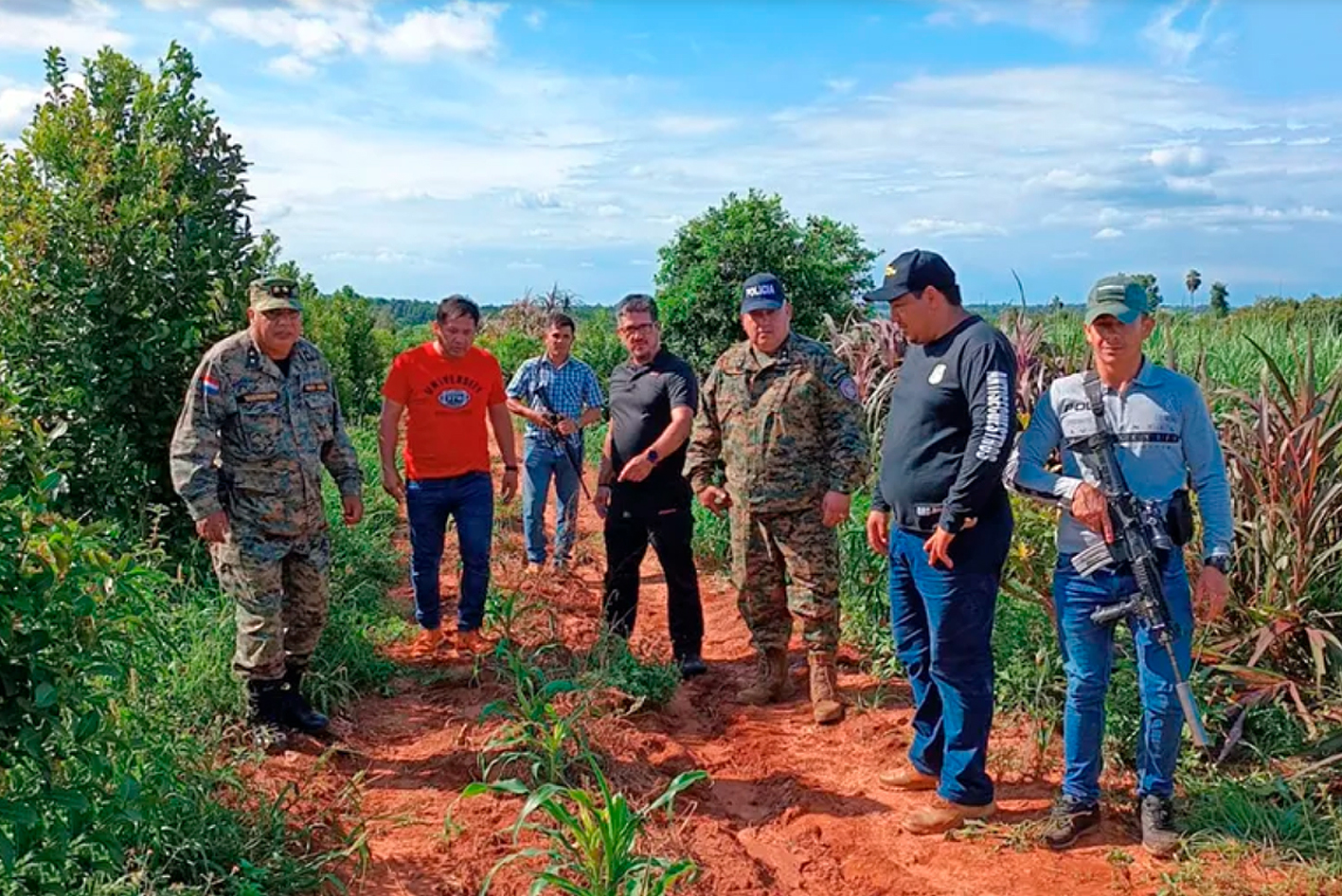 Algemene kommissarisse Wilberto Sánchez en Omar Méndez (albei in kamoefleerdrag) en polisiebeamptes van Paraguay se teenontvoeringseenheid op die plek waar Danie Coetzee se oorskot in 'n suikerietsplantasie aangetref is. Foto: ABC Color