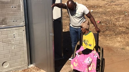 Family of seven happy after flushable pit toilet donation | News Article